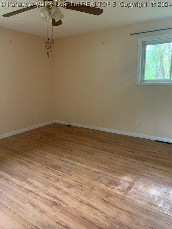 spare room with light hardwood / wood-style floors and ceiling fan