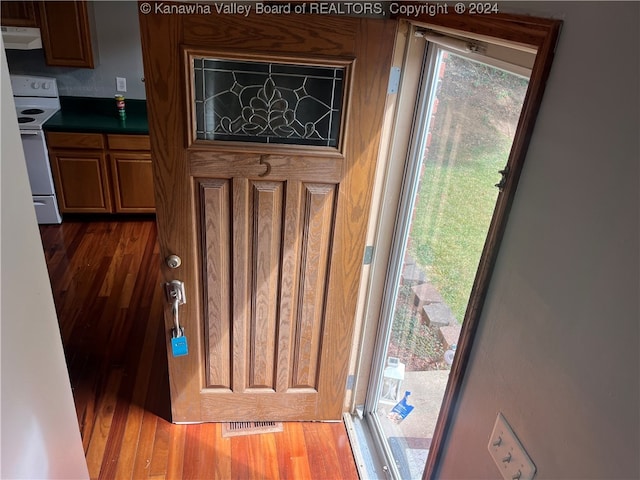 doorway with dark wood-type flooring