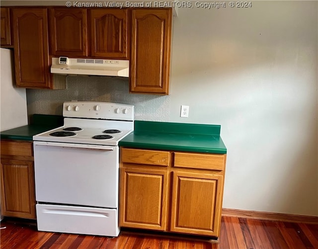 kitchen with white electric range and dark hardwood / wood-style flooring