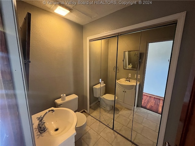 bathroom featuring tile patterned flooring, vanity, and toilet