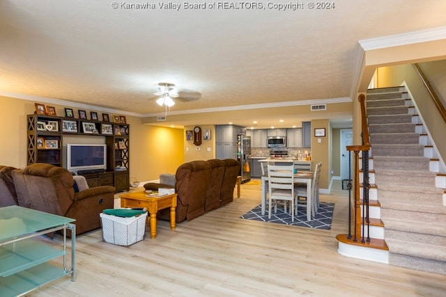 living room featuring ceiling fan, light hardwood / wood-style flooring, and crown molding