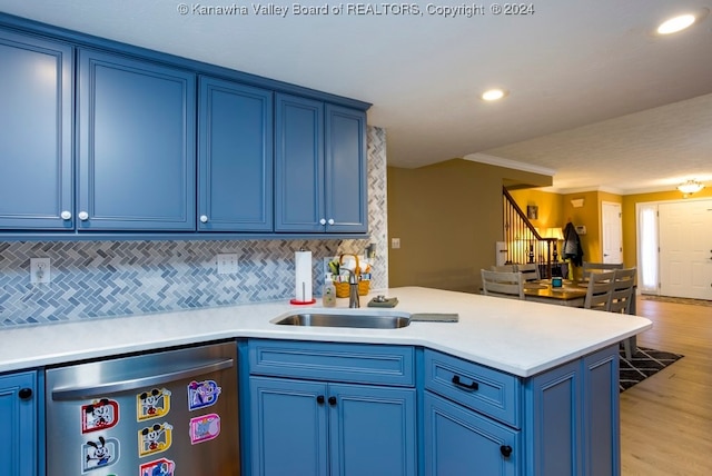 kitchen featuring blue cabinets, dishwasher, light wood-type flooring, and sink