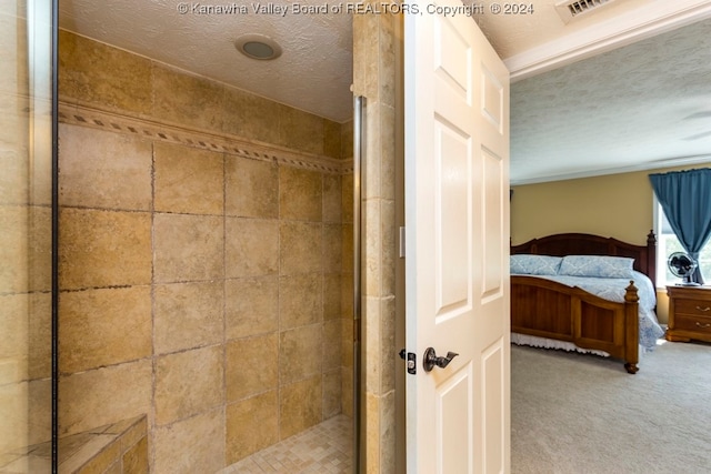 bathroom featuring a textured ceiling and an enclosed shower