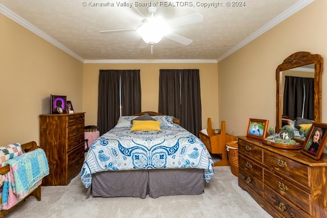 carpeted bedroom featuring ornamental molding, ceiling fan, and a textured ceiling