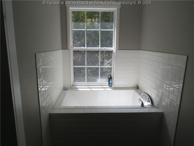 bathroom with tiled tub