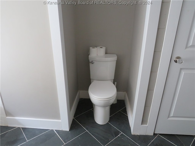 bathroom with tile patterned floors and toilet