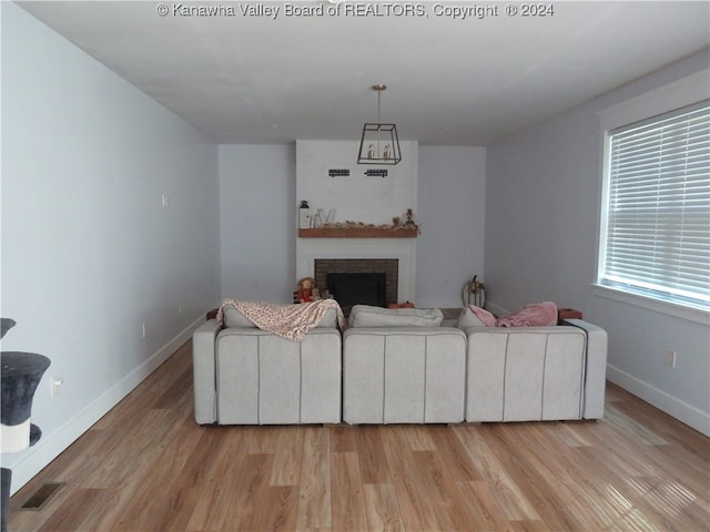 living room featuring a fireplace and light hardwood / wood-style flooring