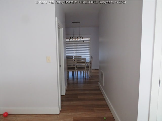 corridor with dark hardwood / wood-style flooring