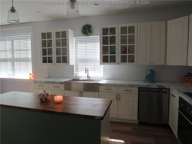 kitchen with dishwasher, dark wood-type flooring, sink, white cabinets, and oven