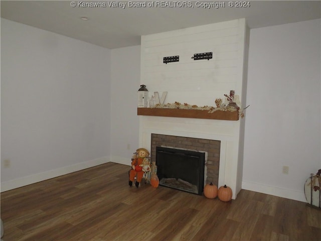 living room with a fireplace and dark hardwood / wood-style flooring