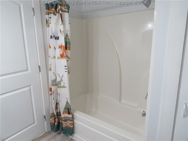 bathroom featuring hardwood / wood-style floors and shower / tub combo