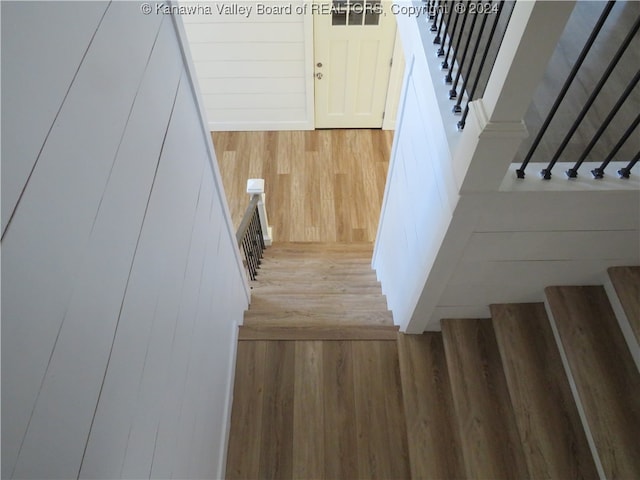 stairs featuring hardwood / wood-style floors