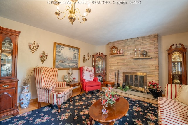 living room featuring wood-type flooring, a notable chandelier, and a fireplace