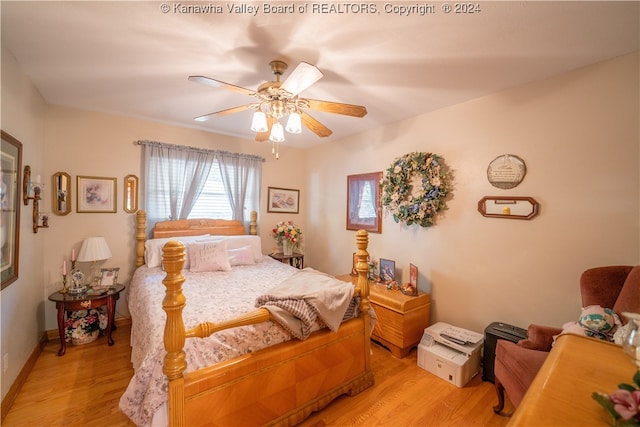 bedroom with light hardwood / wood-style floors and ceiling fan