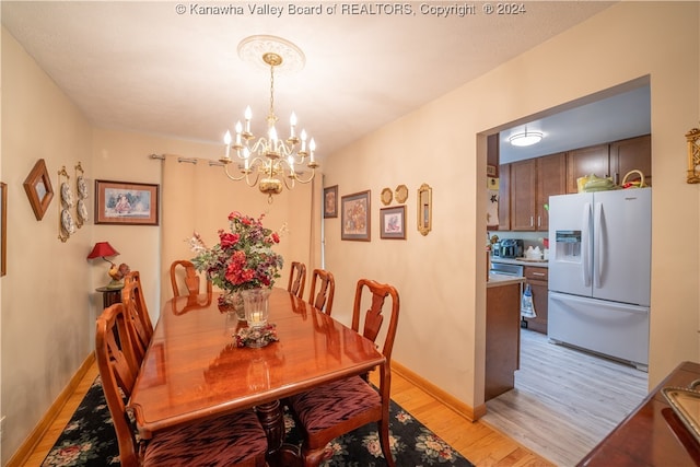 dining room featuring an inviting chandelier and light hardwood / wood-style floors