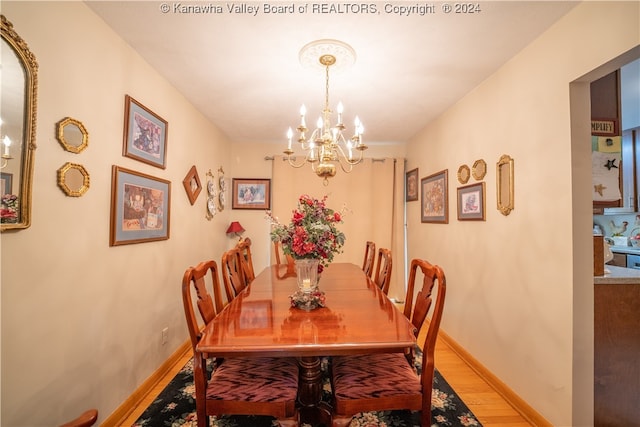 dining space featuring a chandelier and light hardwood / wood-style floors