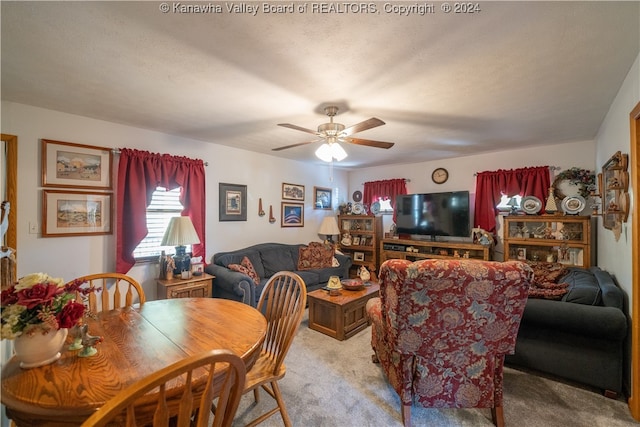 dining room featuring ceiling fan, light colored carpet, and a textured ceiling