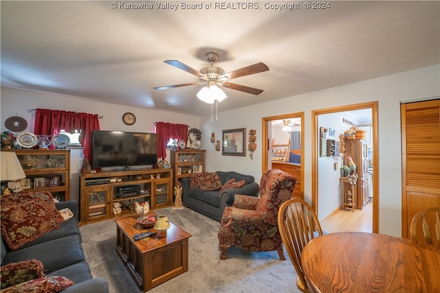 living room featuring ceiling fan and light colored carpet