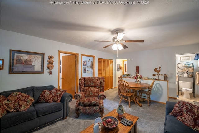 carpeted living room featuring ceiling fan