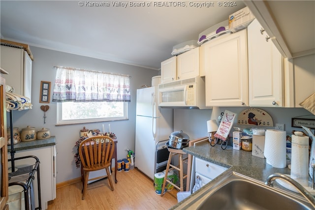 kitchen featuring light wood-type flooring, sink, white cabinetry, white appliances, and crown molding