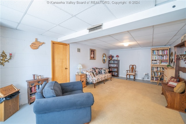 living room with a drop ceiling