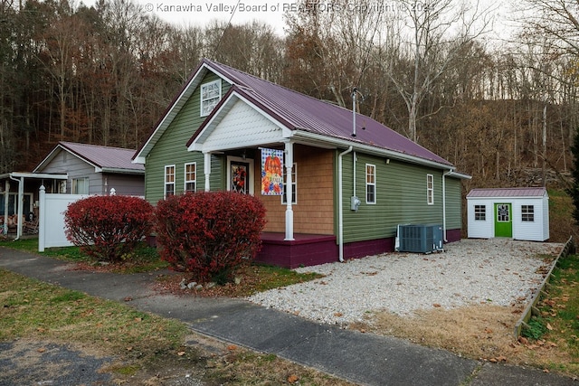 view of front of house featuring an outbuilding and central air condition unit