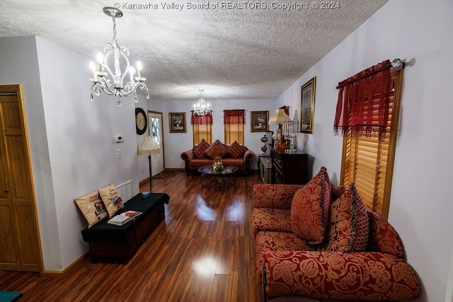 living room with hardwood / wood-style flooring, a textured ceiling, and a chandelier