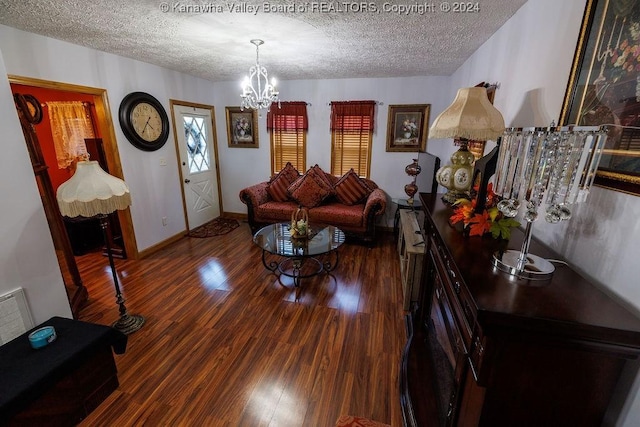 living room featuring wood-type flooring, an inviting chandelier, and a textured ceiling