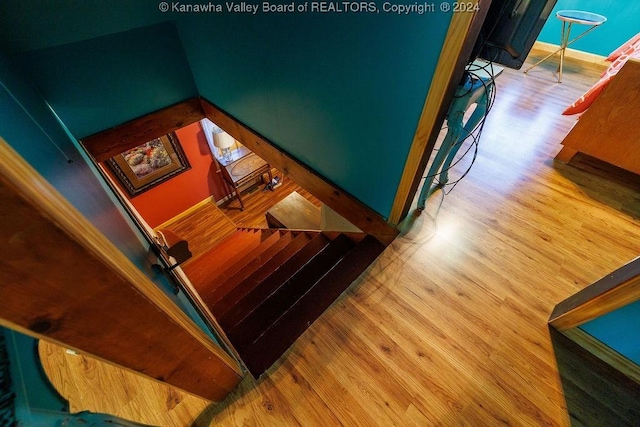 stairway with hardwood / wood-style floors