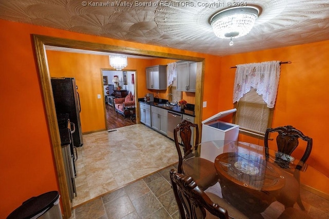 dining area with a notable chandelier and sink