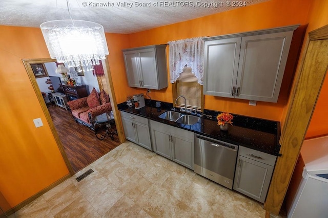 kitchen with pendant lighting, sink, dishwasher, gray cabinetry, and light hardwood / wood-style floors