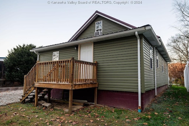 back of house with a deck