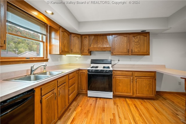 kitchen with custom exhaust hood, sink, white gas range oven, black dishwasher, and light wood-type flooring