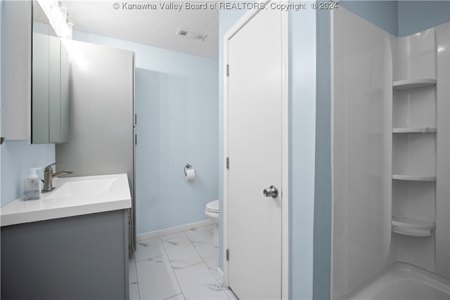 full bathroom with washtub / shower combination, a textured ceiling, vanity, and toilet