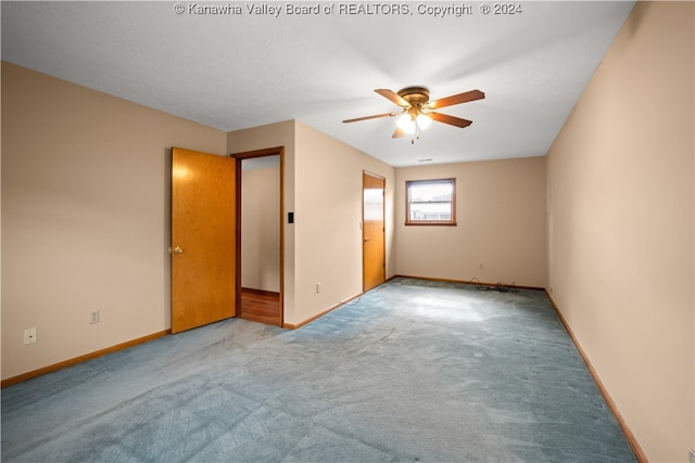 unfurnished bedroom featuring ceiling fan and light colored carpet