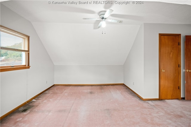 bonus room featuring ceiling fan, light colored carpet, and lofted ceiling