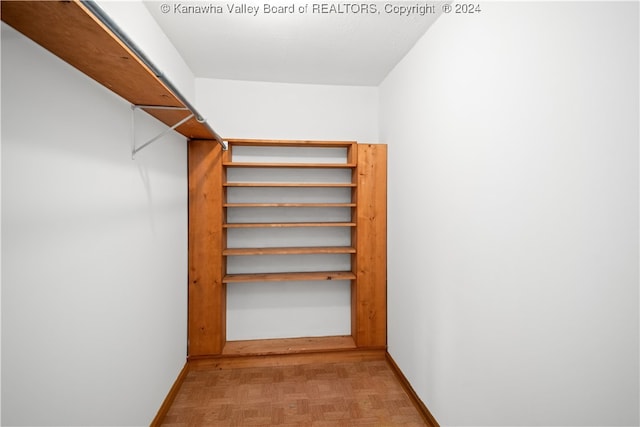 walk in closet featuring light parquet flooring