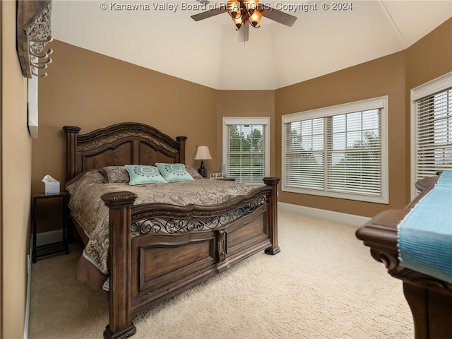 carpeted bedroom featuring ceiling fan and vaulted ceiling