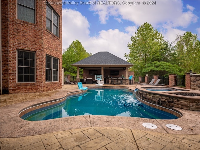 view of swimming pool with an in ground hot tub and a patio