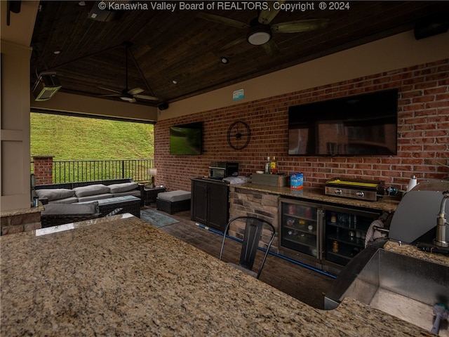 view of patio with an outdoor kitchen, an outdoor living space, and ceiling fan