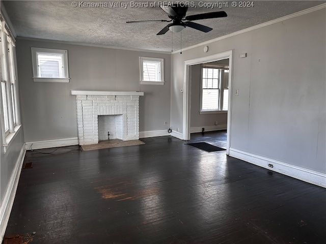 unfurnished living room with a fireplace, a textured ceiling, crown molding, ceiling fan, and dark hardwood / wood-style floors