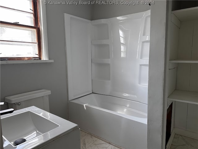 bathroom with shower / bathing tub combination and toilet