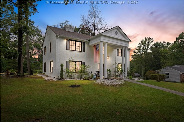 greek revival inspired property with a lawn