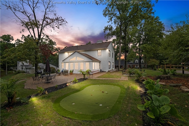 back house at dusk with a patio