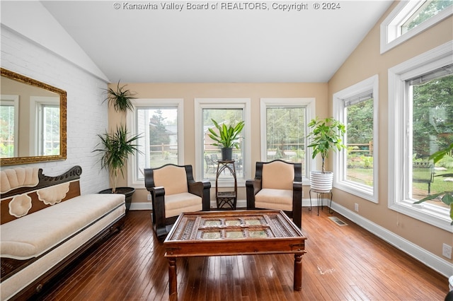 sunroom with a healthy amount of sunlight and vaulted ceiling