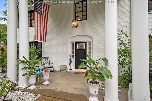 view of exterior entry featuring covered porch