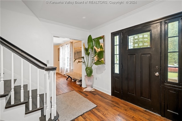 foyer entrance featuring dark hardwood / wood-style floors and ornamental molding