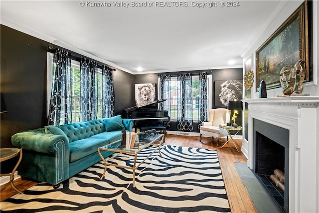 living room with hardwood / wood-style flooring, a healthy amount of sunlight, and crown molding