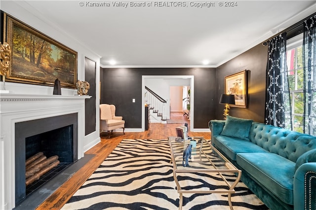 living room featuring wood-type flooring and crown molding