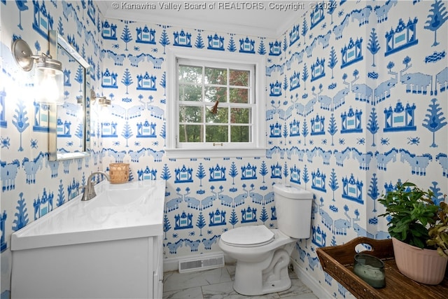 bathroom featuring crown molding, vanity, and toilet